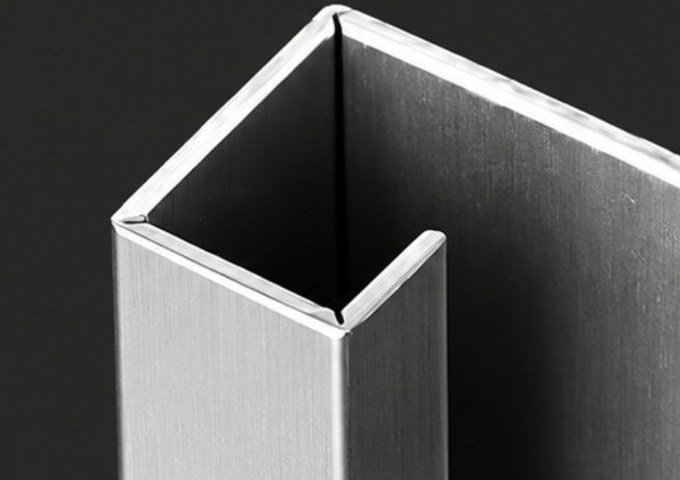 Folded stainless steel channel with a sharp 90° outside corner, V-grooved before bending