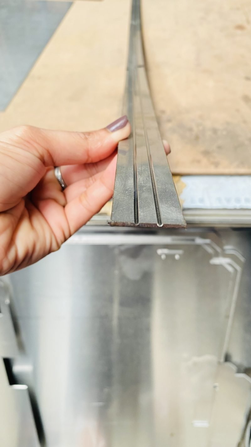 The web of metal left at the bottom of each groove carries the corner