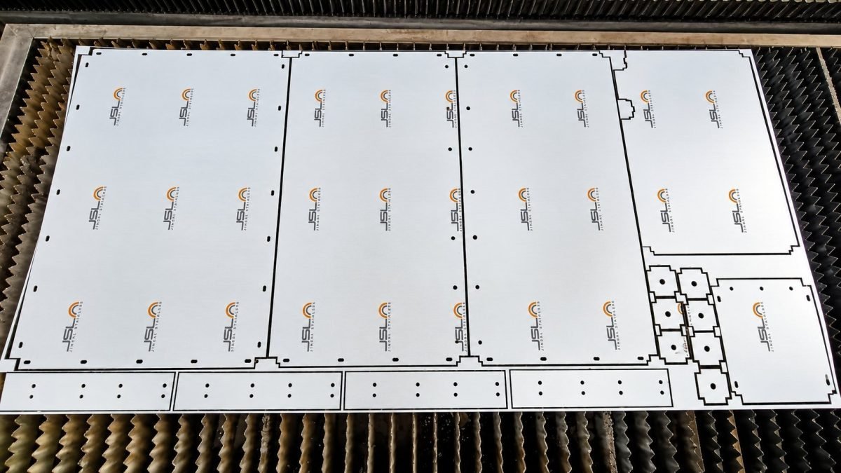 Laser-cut stainless steel panels nested on the cutting bed