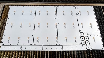 Laser-cut stainless steel panels nested on the cutting bed