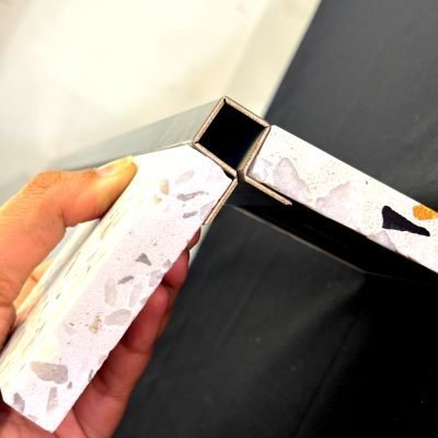 Corner guard sample held against a terrazzo corner