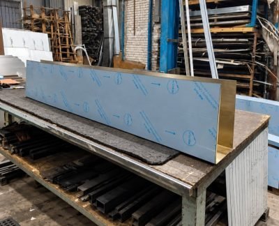 Long custom U channel with protective film at the fabrication shop