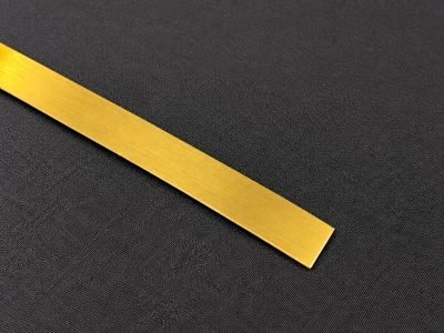 Illustration: flat patti strip in brushed brass — Flat Patti · Architectural Profiles