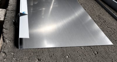 Wide stainless steel J profile with a folded return edge on the workshop floor
