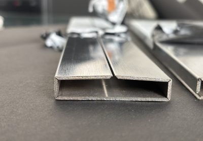 Rectangular stainless steel pipe sections stacked