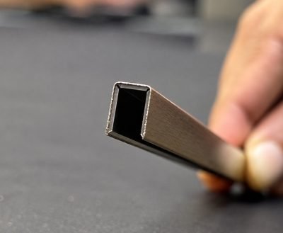 Illustration: small C channel in brass held in hand