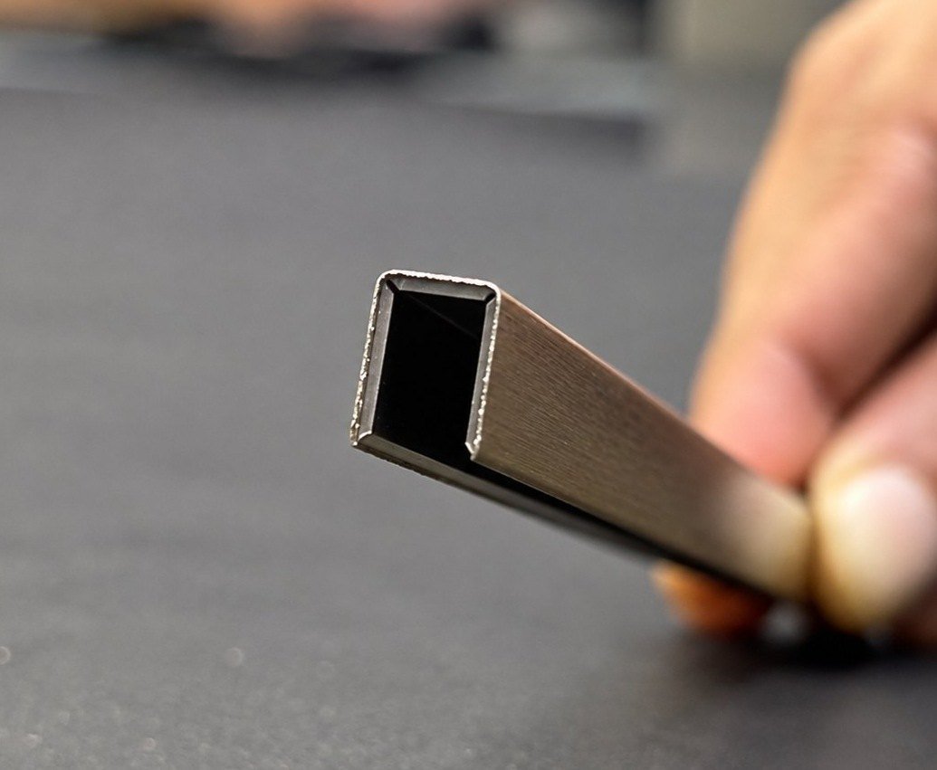 Illustration: small C channel in brass held in hand