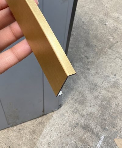 Brushed brass U profile held in hand