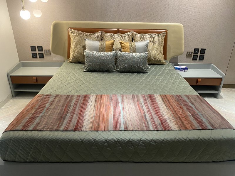 Bedroom with metal-trimmed wardrobe and headboard wall