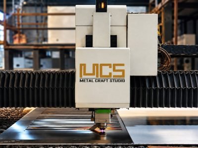 CNC fibre laser cutting head over the cutting bed