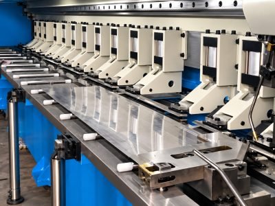 CNC V-grooving machine bed with a stainless steel sheet in place