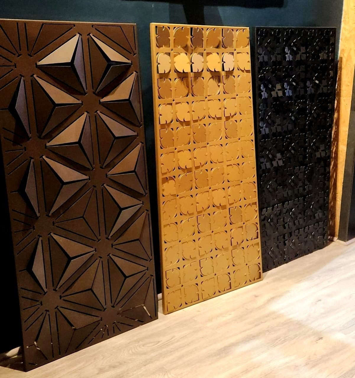 3D folded façade panels with star and dot patterns in brass and bronze