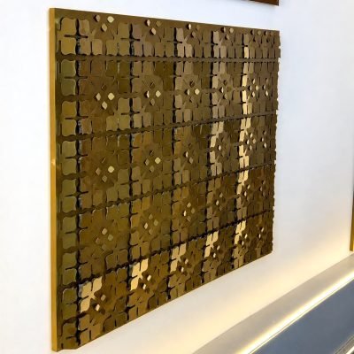 3D folded façade panel with a dotted relief, brass finish
