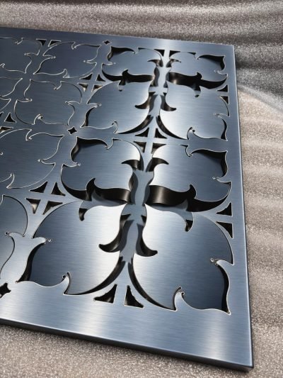 3D folded façade panel with a floral laser-cut pattern, black