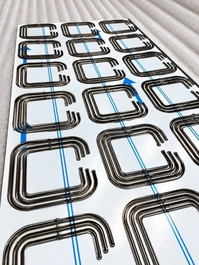 3D folded façade panel with folded square tabs, protective film on