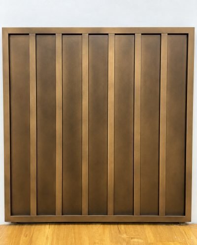 Inter-lock wall panel with vertical ribs in bronze, on the showroom floor
