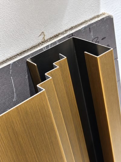 Inter-lock panel profiles in brushed bronze finish, end view
