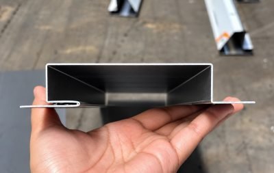 Inter-lock panel section held in hand, end view