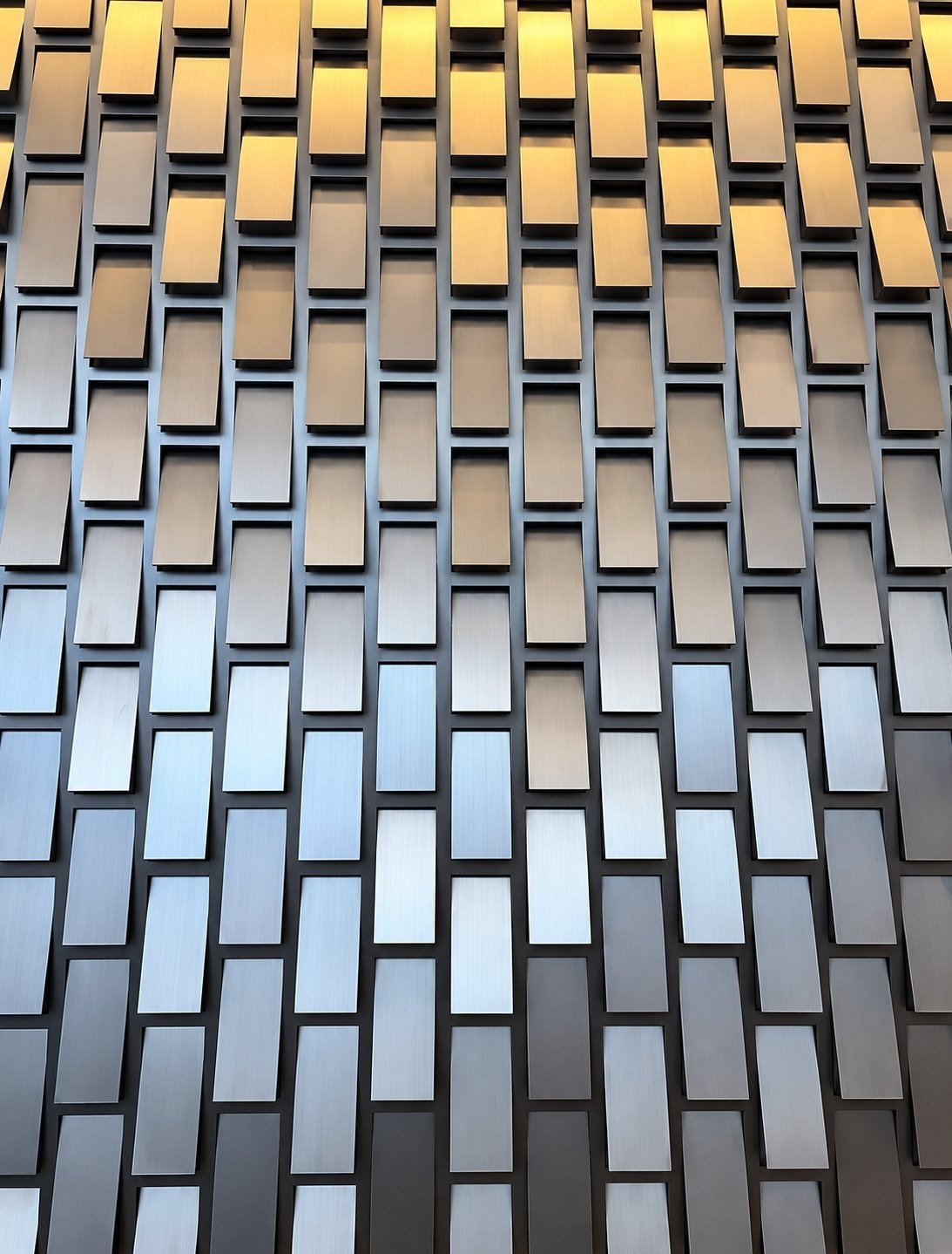 Kinetic façade panel with angled stainless steel tiles, close view