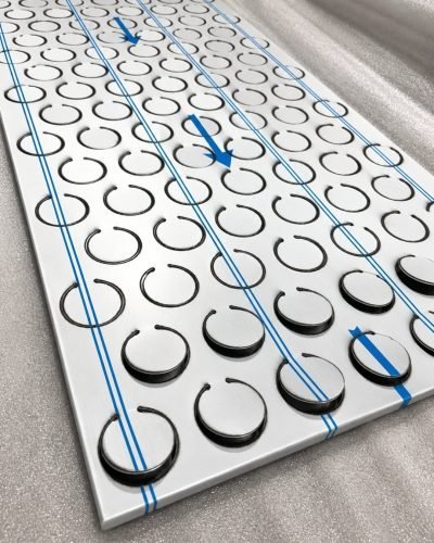 Metal coin façade panel with protective film, half-punched discs