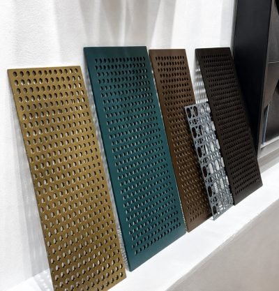 Perforated panel samples in bronze, green, gold and stainless finishes — Perforated Façade Panels · Façade Systems