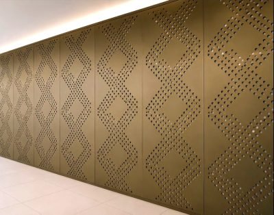 Perforated façade panels with a diamond motif in bronze finish, installed