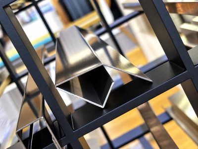 Illustration: floor edge profiles in stainless steel on a display frame — Floor Edge Profiles · Flooring