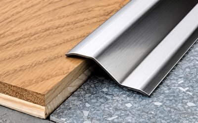 Illustration: floor edge profile in stainless steel between timber and stone — Floor Edge Profiles · Flooring