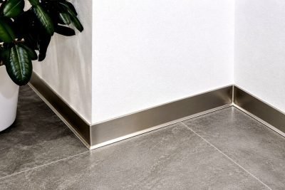 Illustration: stainless steel skirting running around a room corner
