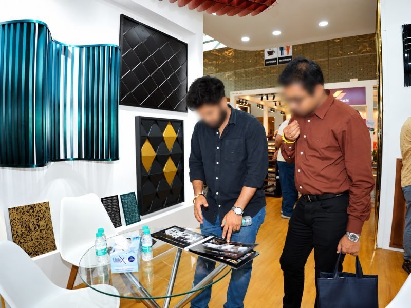 Visitors at the stand with parametric wall and shingle samples