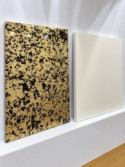 Kitchen shutter samples in patterned gold and plain white finishes