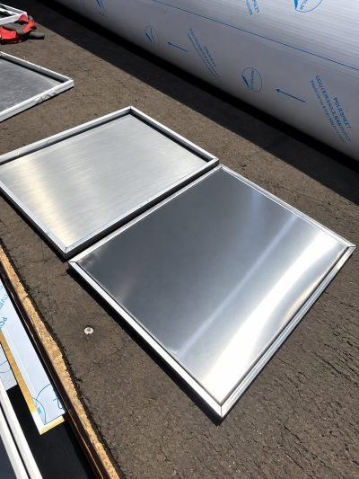 Kitchen shutter panels in brushed stainless steel on the bench