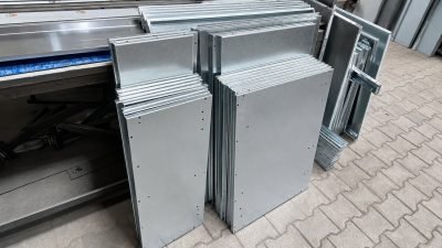Illustration: metal kitchen panels stacked at the workshop