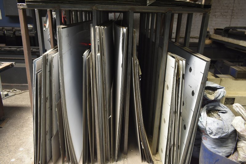 Laser-cut sheet metal parts racked in the workshop
