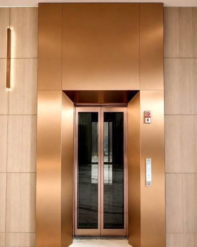 Lift cladding in copper finish with a lift door