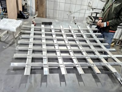 Metal ceiling grid laid out on the workshop floor — Ceiling Grid Systems · Metal Ceilings