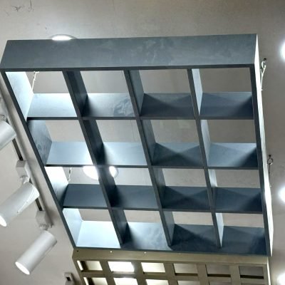 Open-cell metal grid ceiling in dark grey, seen from below — Ceiling Grid Systems · Metal Ceilings