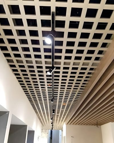 Perforated metal ceiling panels installed in a corridor — Ceiling Grid Systems · Metal Ceilings