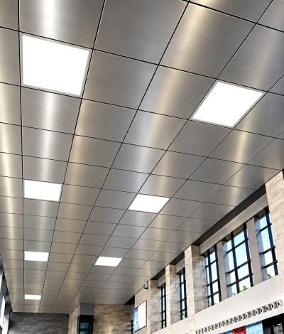 Lay-in metal ceiling panels with lighting in an office