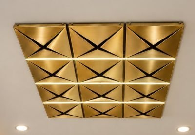 Designer ceiling system in brass finish with triangular folds and lighting