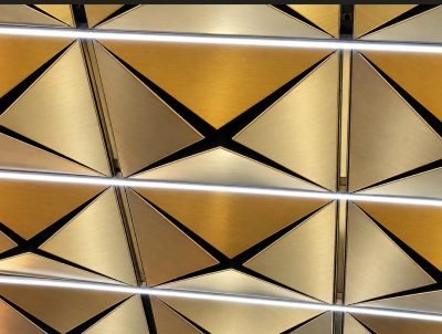Brass-finish triangular ceiling panels, close view