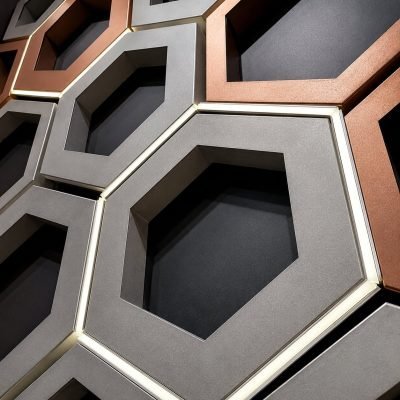 Honeycomb ceiling panels in grey and copper finishes