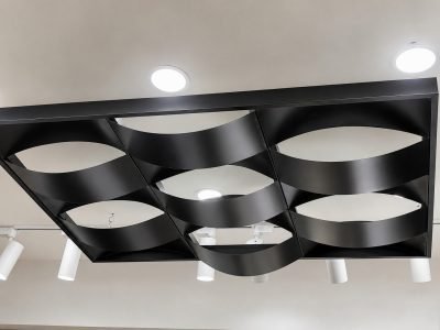 Black wave metal ceiling with curved strips in a grid frame