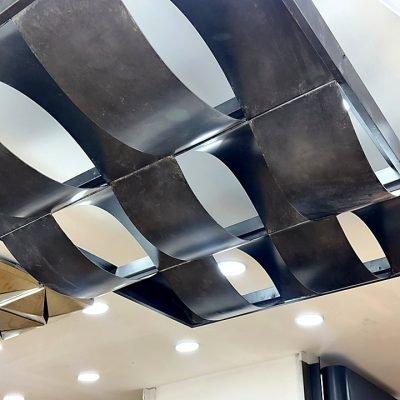 Wave-form metal ceiling in black and silver, installed