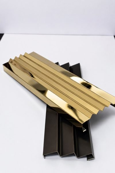 Illustration: zig-zag louver strips in brass and black finishes — Zig-Zag Louvers · Metal Louvers