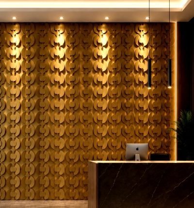 3D coin shingles in brass finish on a reception wall