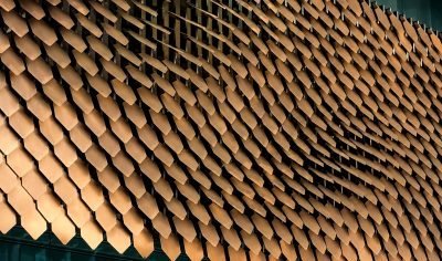 Exposure adjustment shingles in copper finish, angled wall