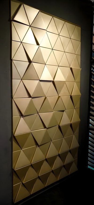 Triangular metal shingles in brass finish, wall panel