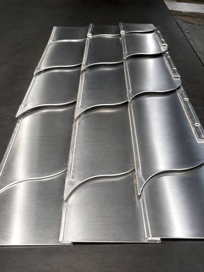 Wave pattern shingles in brushed stainless steel, panel