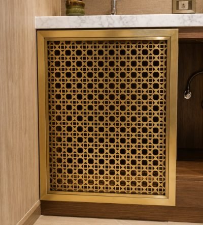 Illustration: architectural mesh screen in brass on a vanity unit